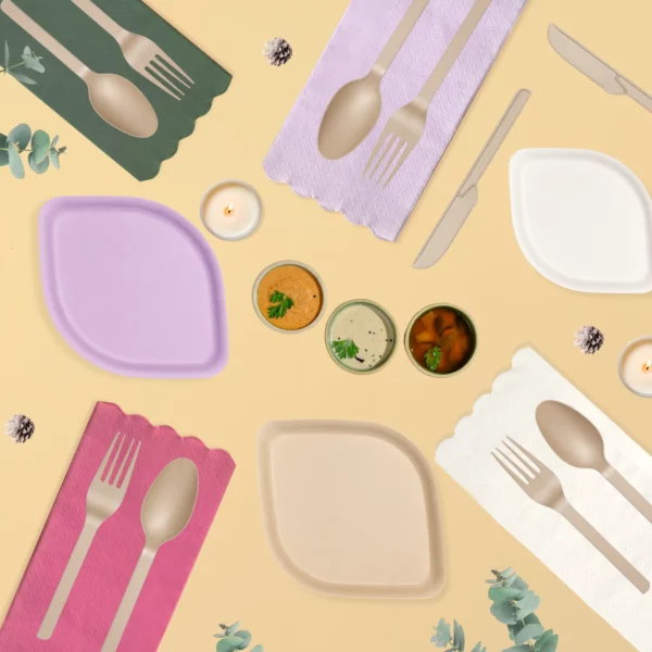 Colorful table with pastel plates, cutlery, candles, spruce cones, eucalyptus, and dips on beige background, elegant cozy.